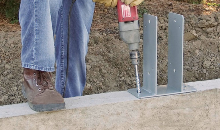 Sturdi-Wall post-frame anchor brackets drill set in concrete